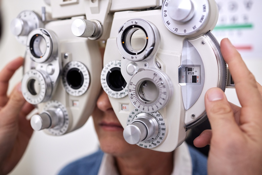 Patient undergoing detailed vision testing using a phoropter during PRK evaluation – PRK