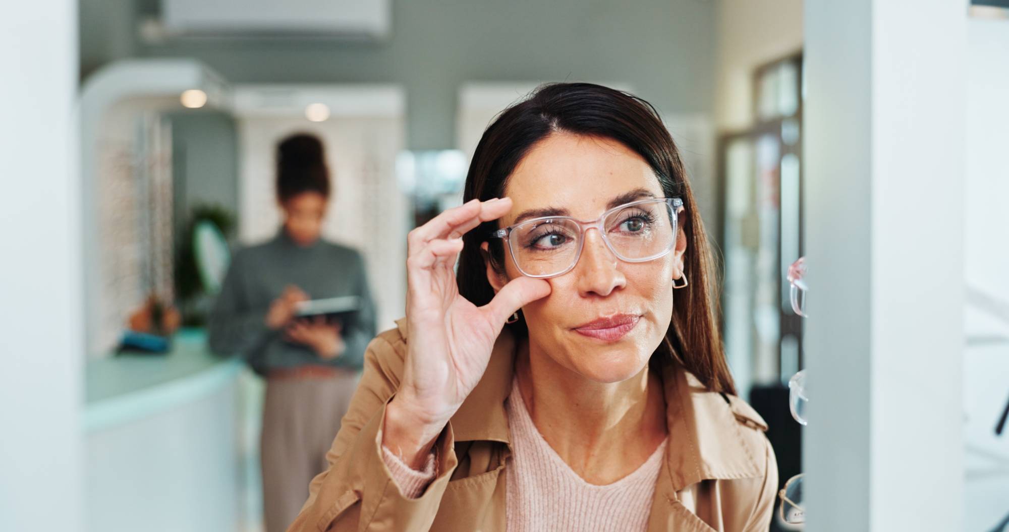 Eye care, woman and glasses choice in mirror for frame shopping, prescription lens size and eyewear fitting. Mature person, eyesight and check for vision correction and optical health in retail store