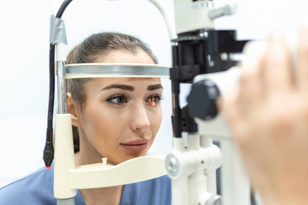 Eye doctor with female patient during an examination in modern clinic. Ophthalmologist is using special medical equipment for eye health