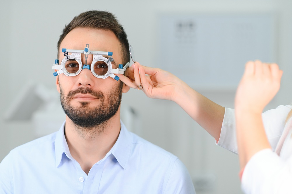 Eye doctor adjusting trial frames during a refraction exam to assess candidacy for PRK – PRK