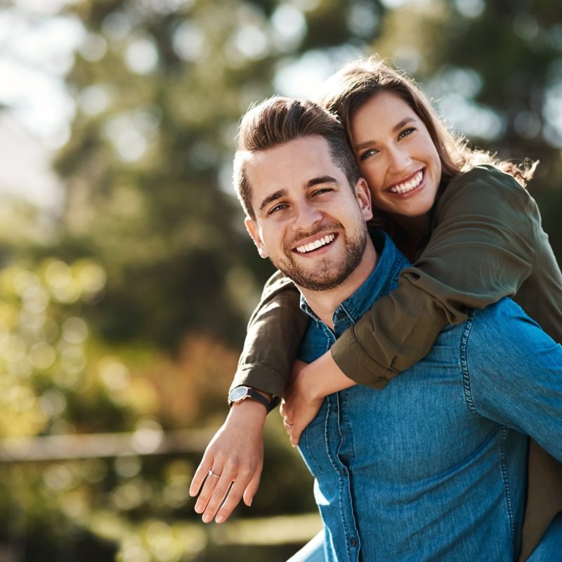Smiling couple outdoors embracing confidently, representing improved vision and freedom after treatment – RLE Eye Surgery