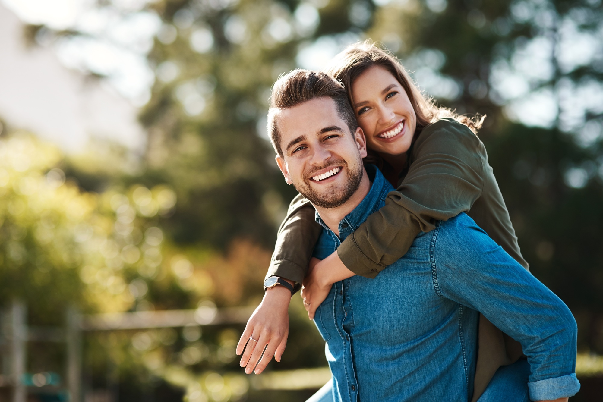 Smiling couple outdoors embracing confidently, representing improved vision and freedom after treatment – RLE Eye Surgery