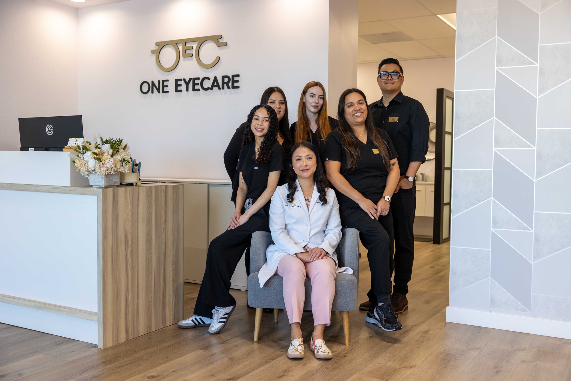 One Eyecare ophthalmology team posing in the clinic lobby, supporting patients through advanced Intraocular Lens Implants – Intraocular Lens Implants