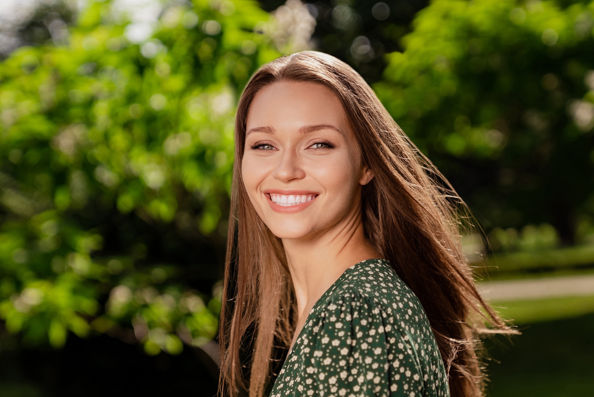 Confident woman smiling outdoors with bright, clear eyesight following advanced vision treatment – Visian ICL